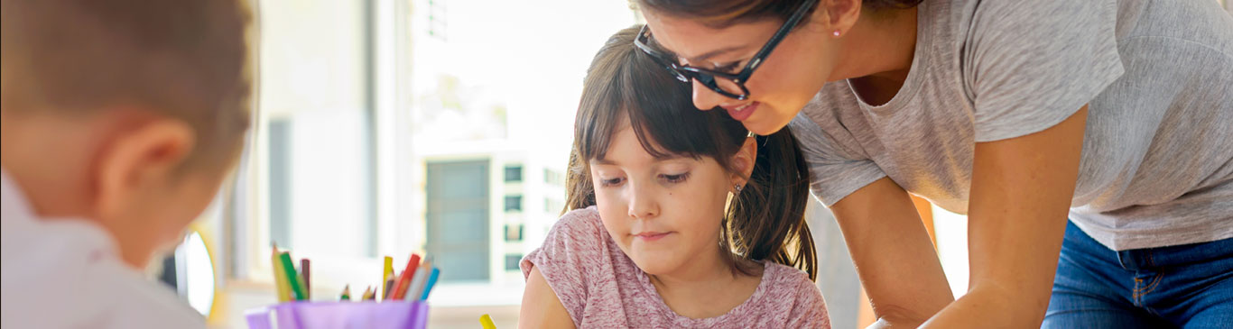 Teacher helping young student