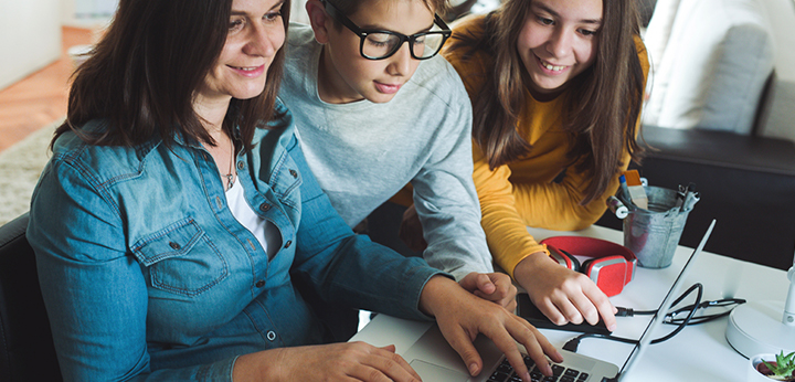 Teachers and students working together on a computer